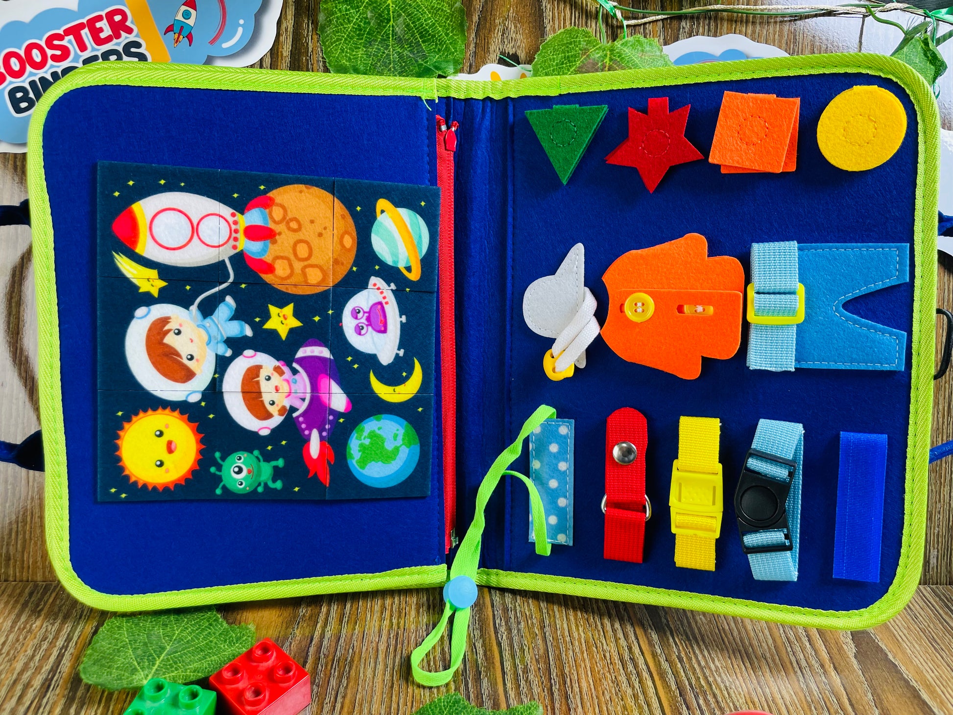 Open book with colorful felt shapes 